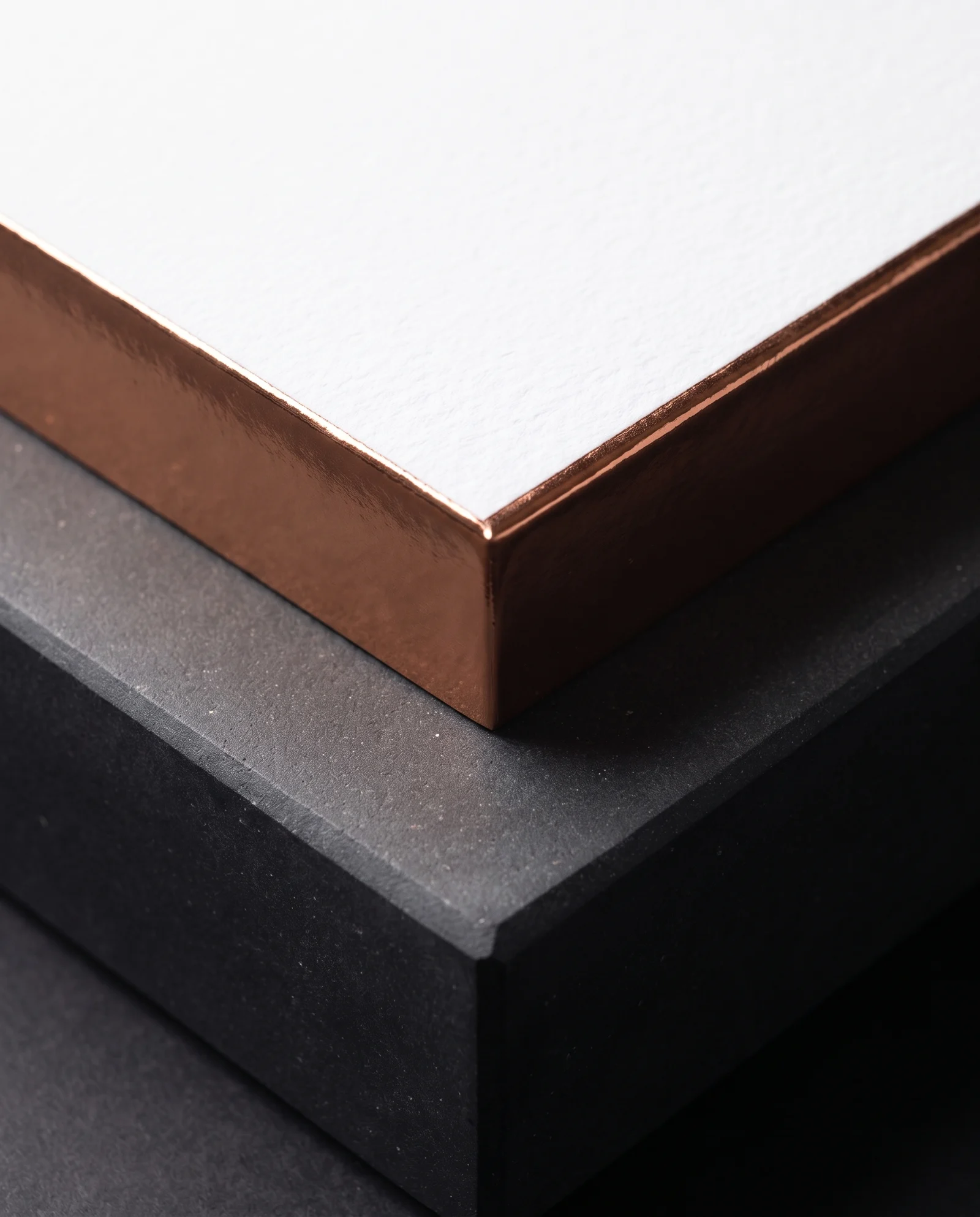 Macro of copper edge foil running seamlessly around a square corner.