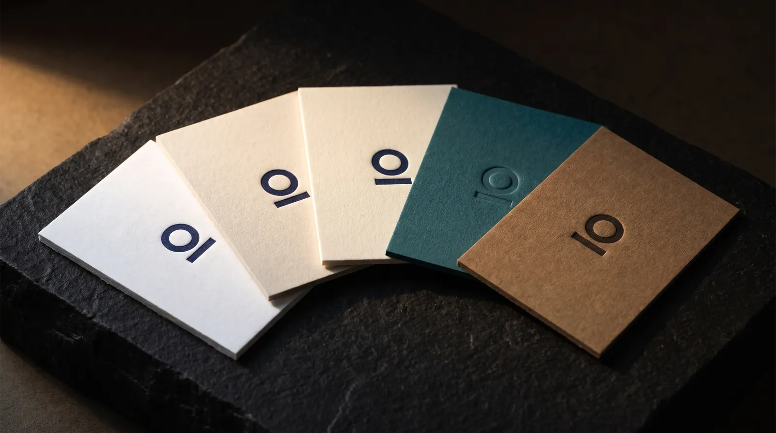 Cotton and specialty paper swatches fanned out on a table.