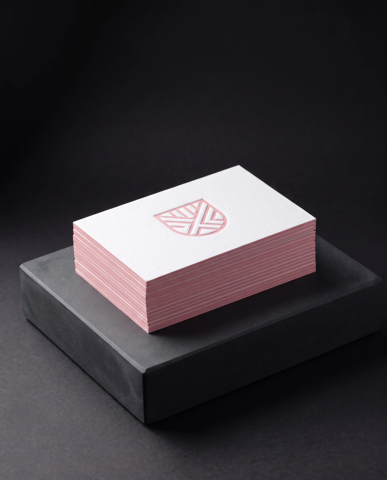 Blush-pink painted edge matched to a blush-pink letterpress mark.