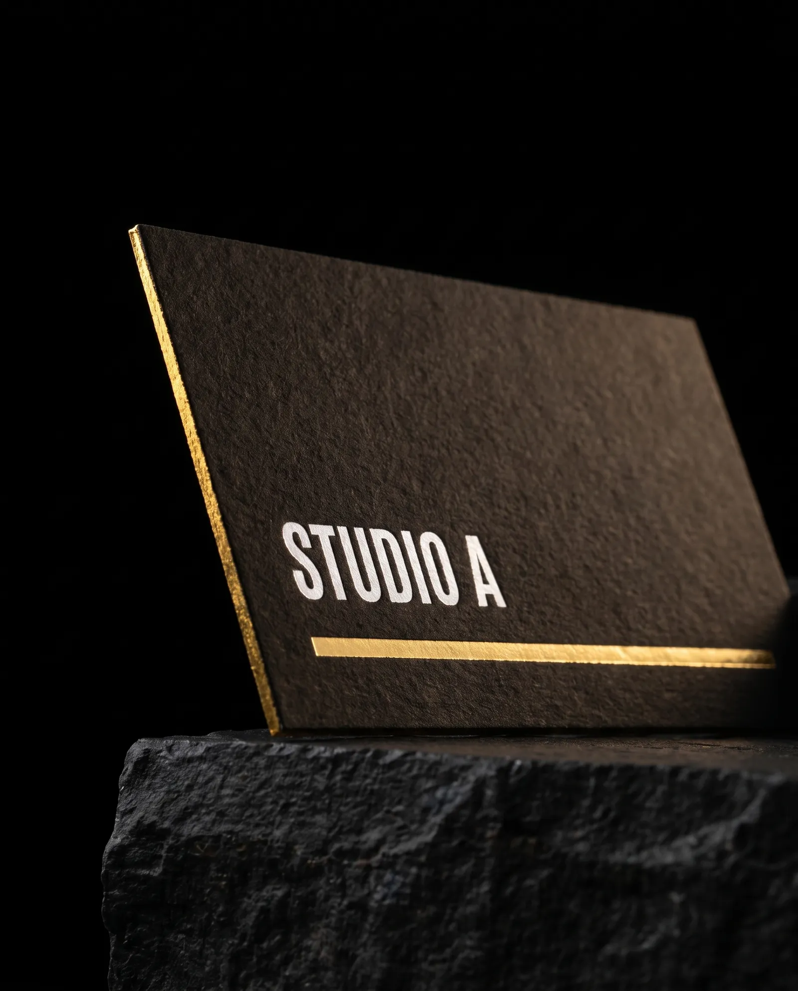 Black cotton business card with white pigment foil name, gold foil rule and gold foiled edge