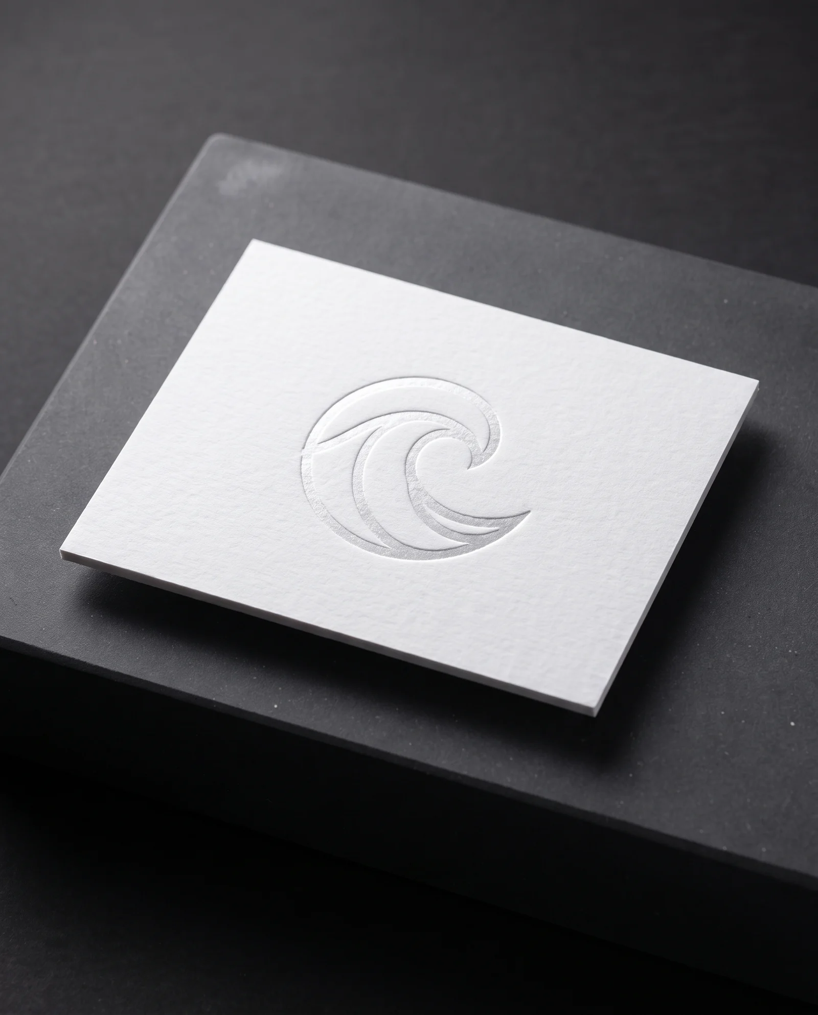 Clear foil pressed into white cotton, a satin shine in the impression.