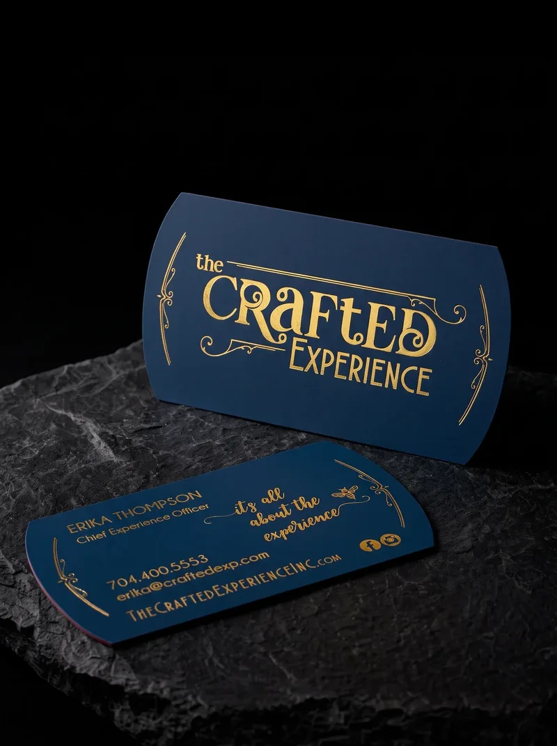 Two notched die-cut business cards, one white and one navy, with gold foil