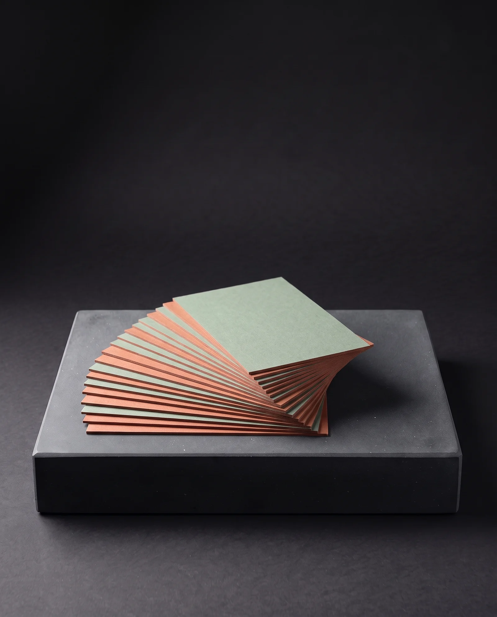 Sage and terracotta duplex cards fanned to show both faces.