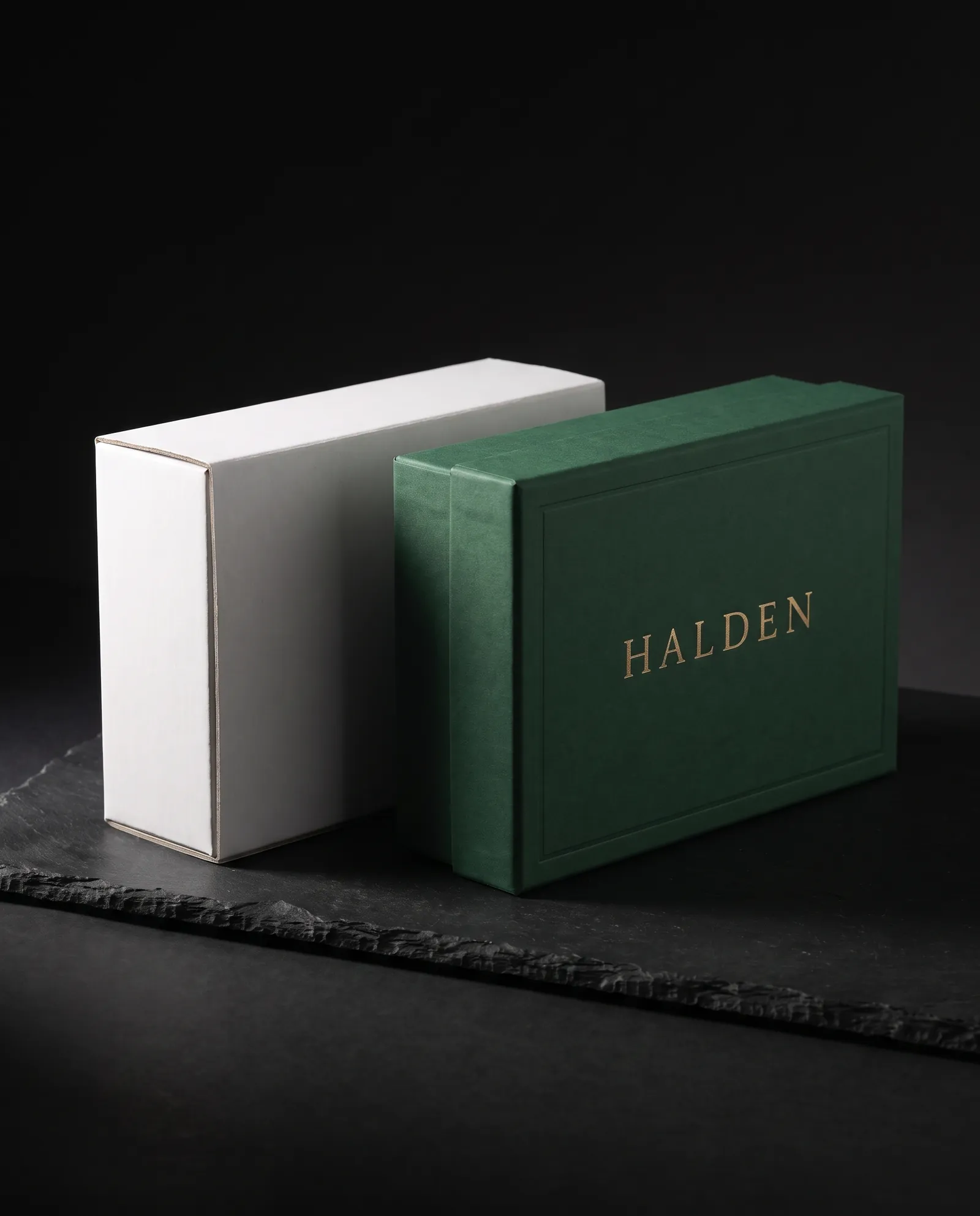 An unprinted white structural prototype beside the finished green rigid box