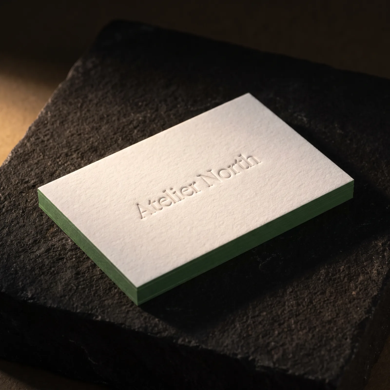 48pt cotton business card with blind debossed name and forest green painted edge