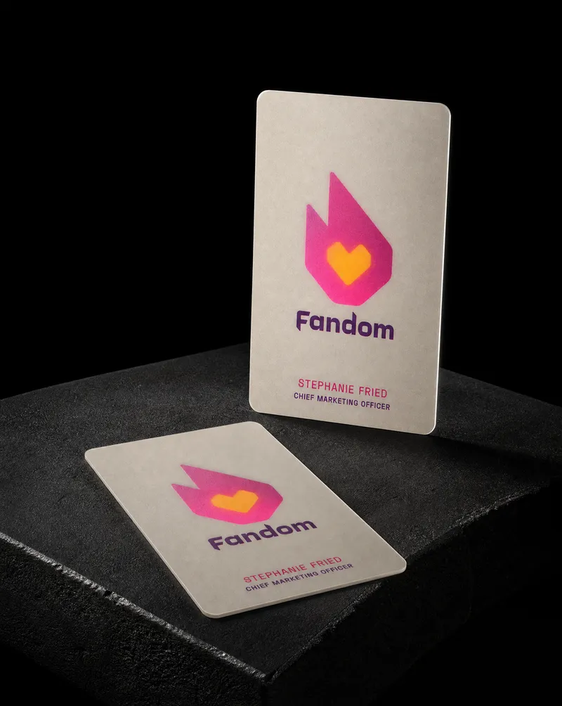 Frosted plastic business card with an opaque white face and a translucent flame logo glowing through