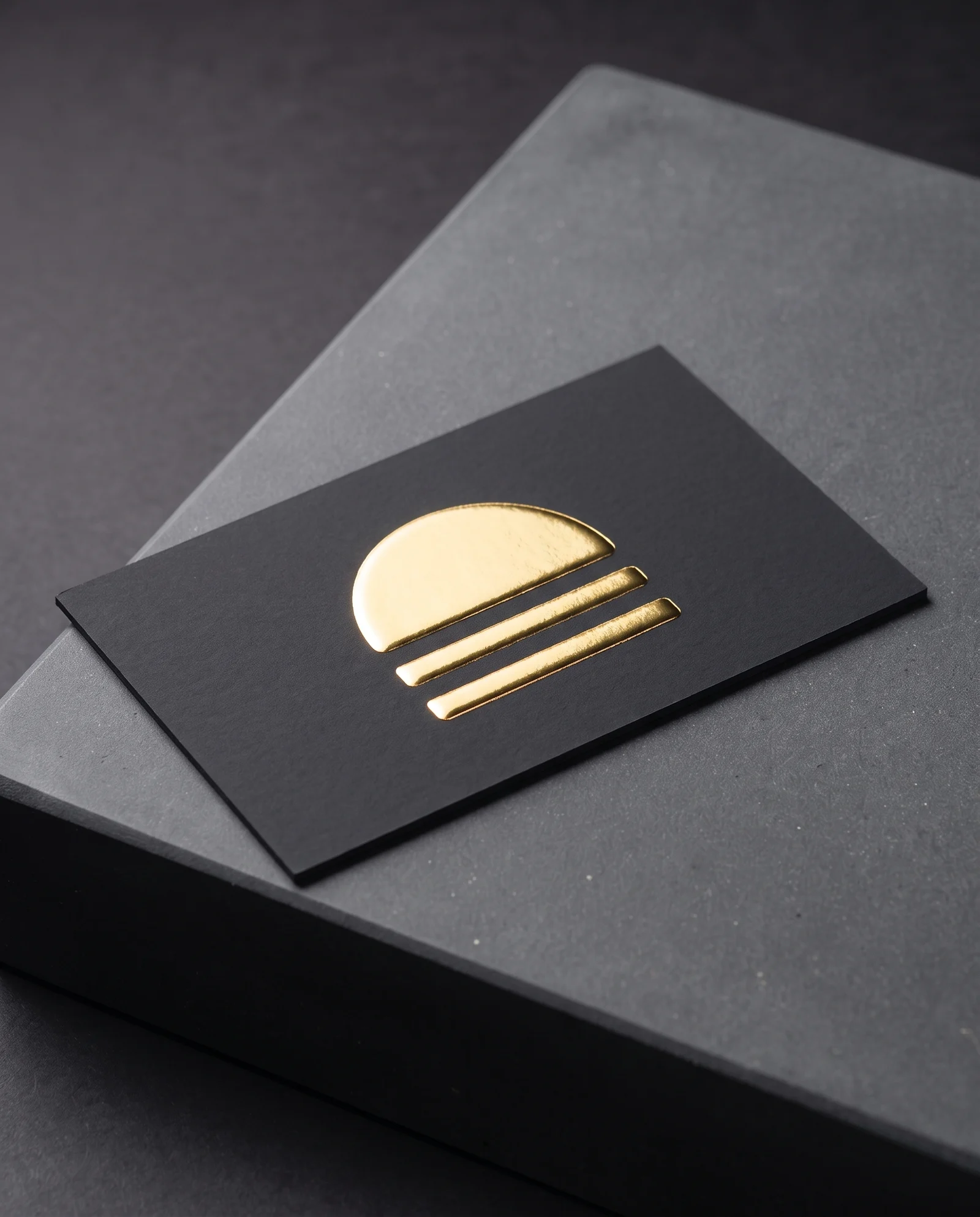 Raised digital gold foil standing above a black soft-touch card.