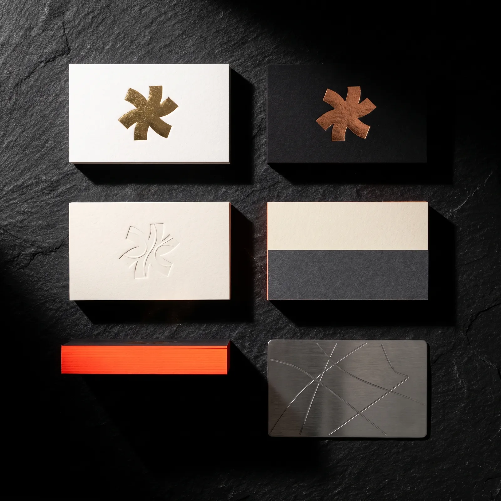 Flat lay of six card builds: gold and copper foil, deboss, duplex, painted edge, steel