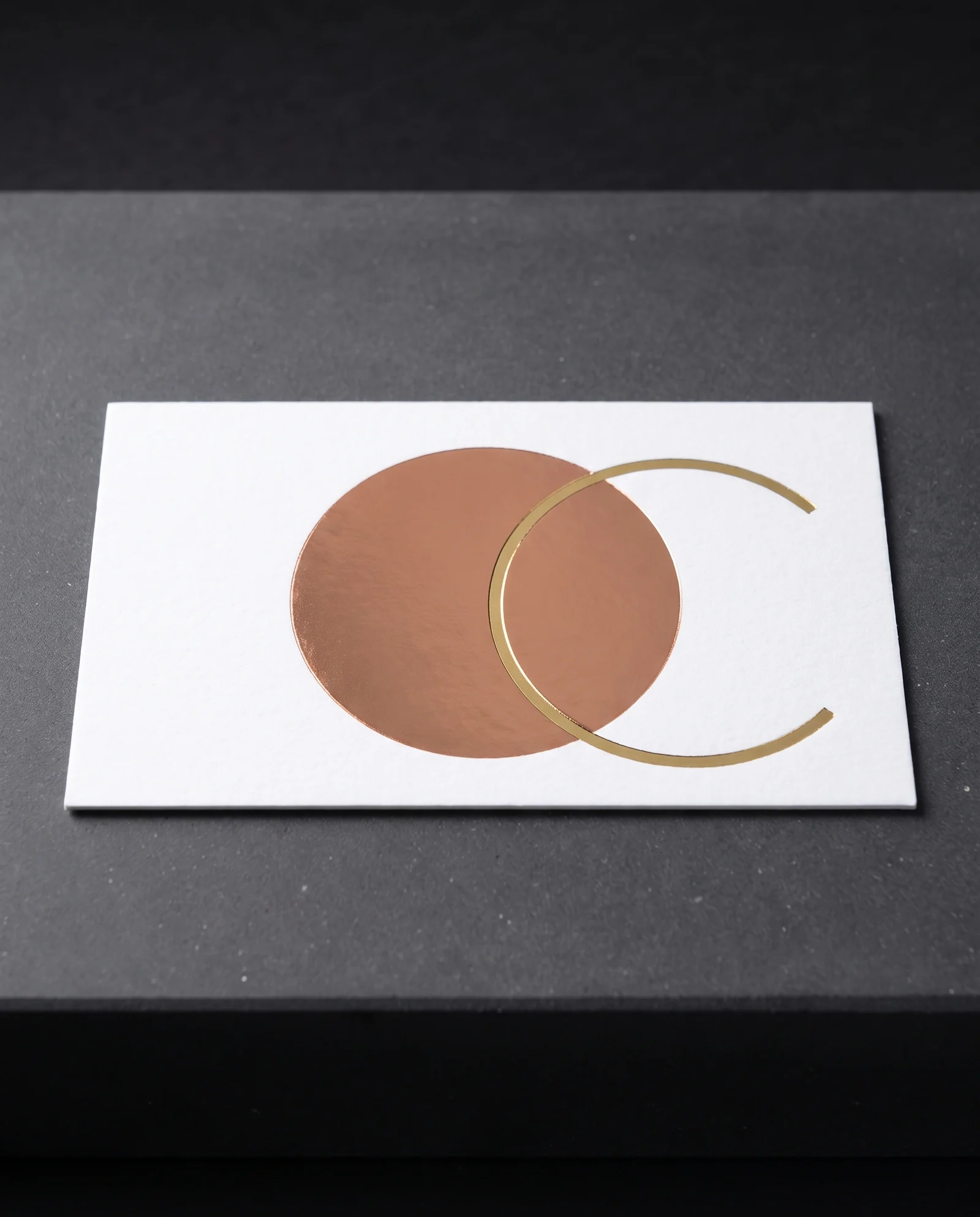 Gold foil stamped over copper foil, the overlap visible as a fine step.