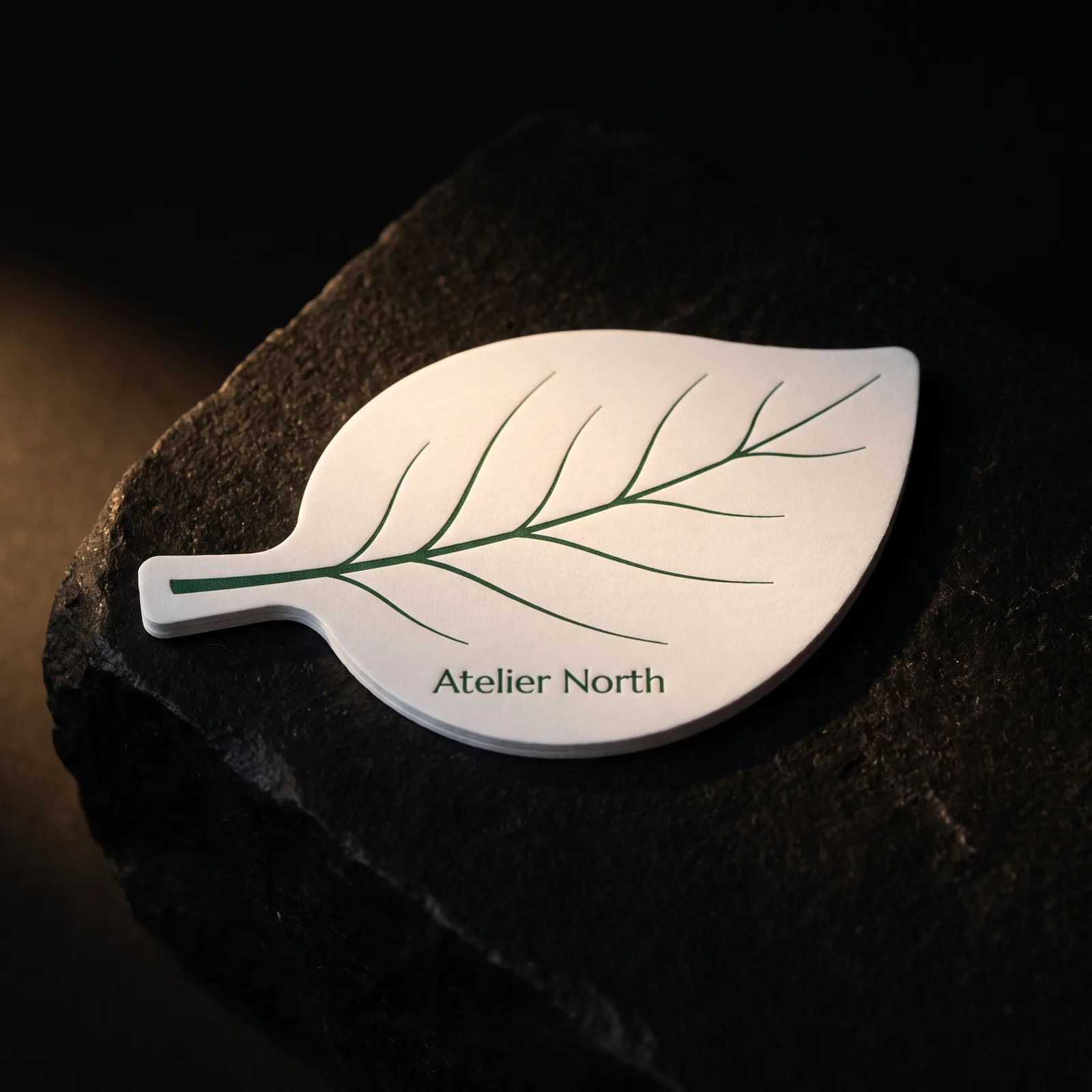 Leaf-shaped die cut business card on white silk stock with green vein print