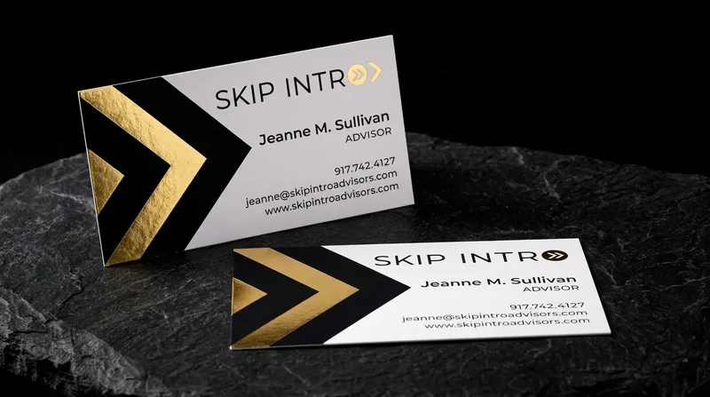 White business card with large gold and black foil chevrons pointing right