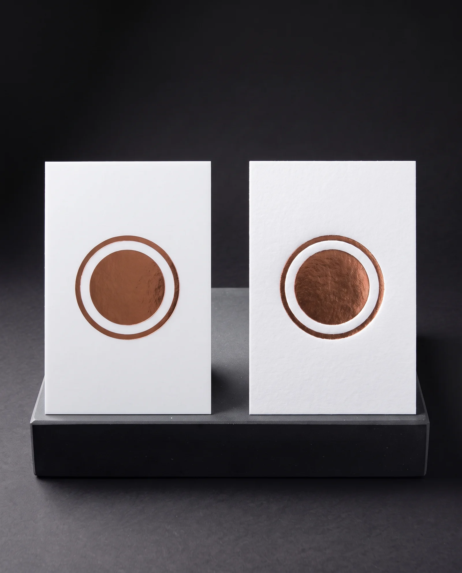 The same copper foil on soft-touch laminate (glass-smooth) and on cotton (pressed in, picking up the paper tooth).