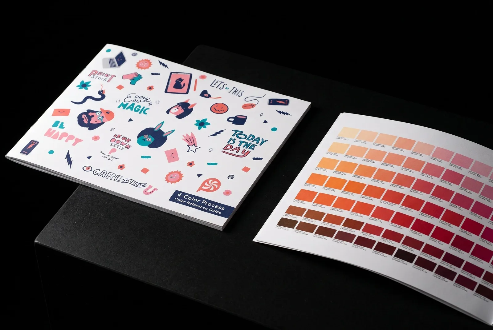 The Peppermint 4-Color Process Color Reference Guide, cover and an open page of printed colour chips, on black stone.