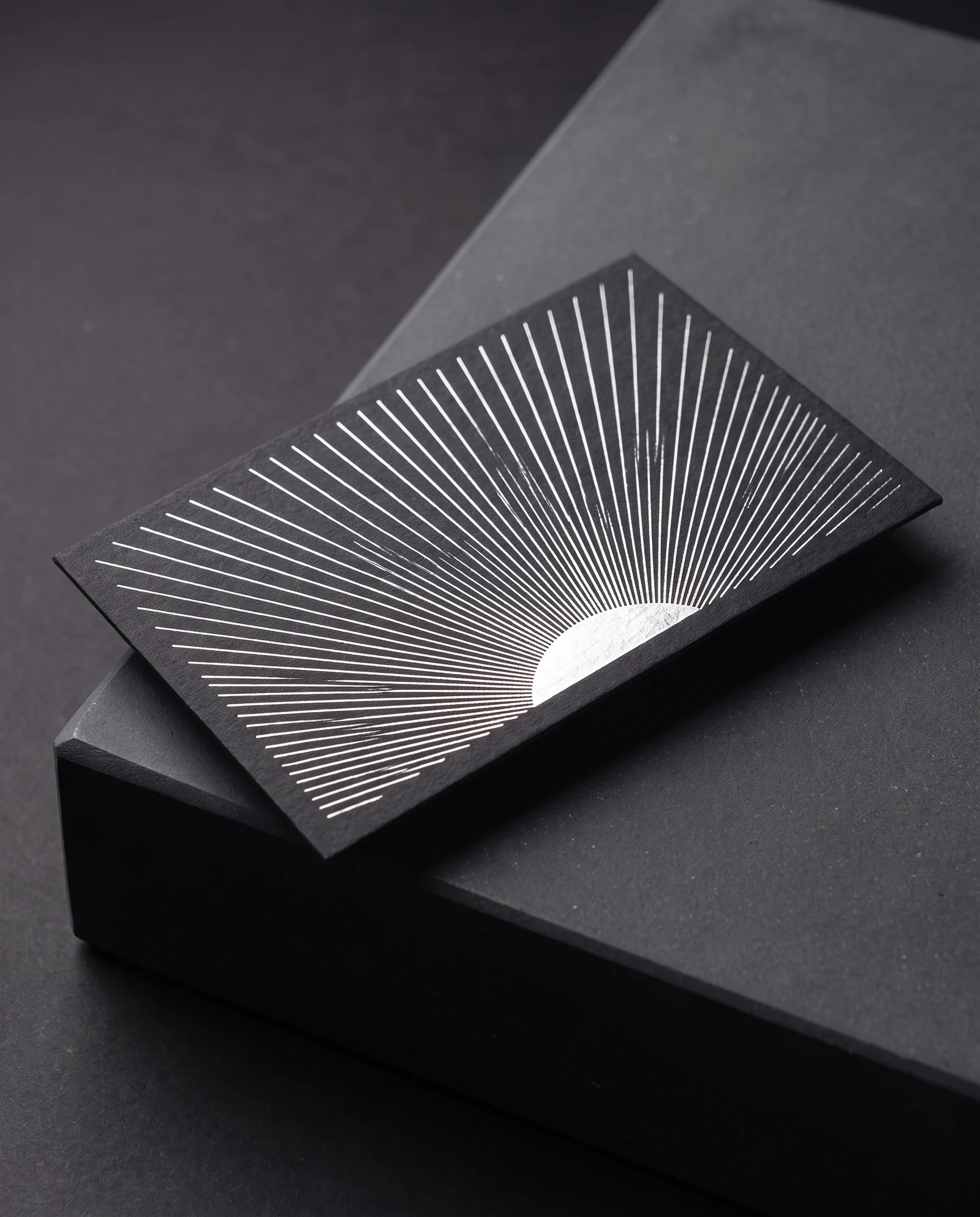 Hairline silver foil pressed into black cotton, every line crisp.