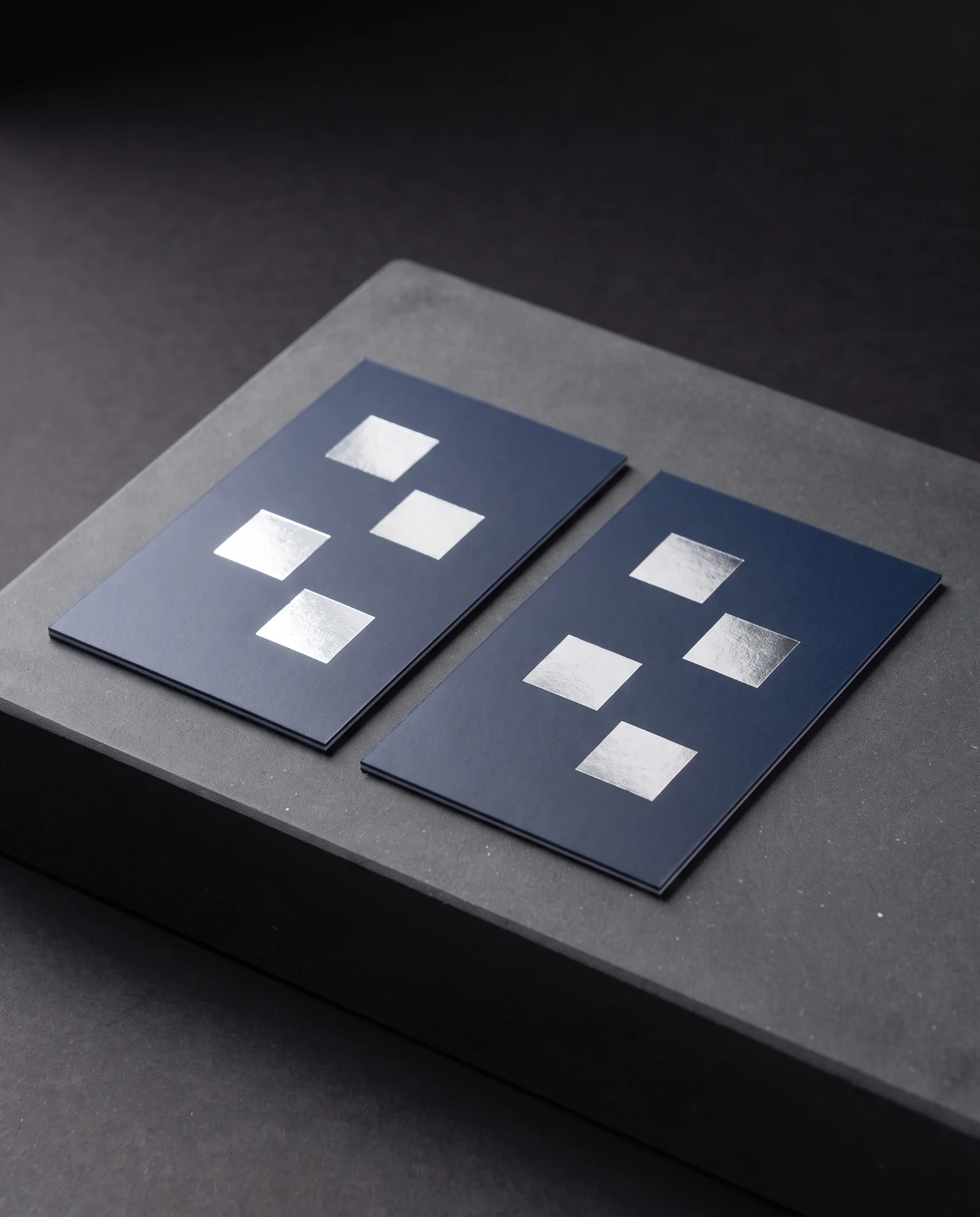 Silver foil lying flat and sharp on navy matte-laminated cards.