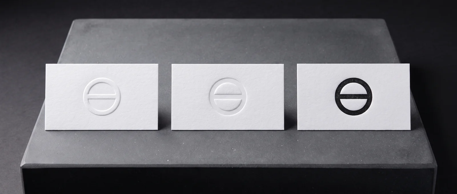 Emboss, blind deboss and letterpress side by side in white cotton.