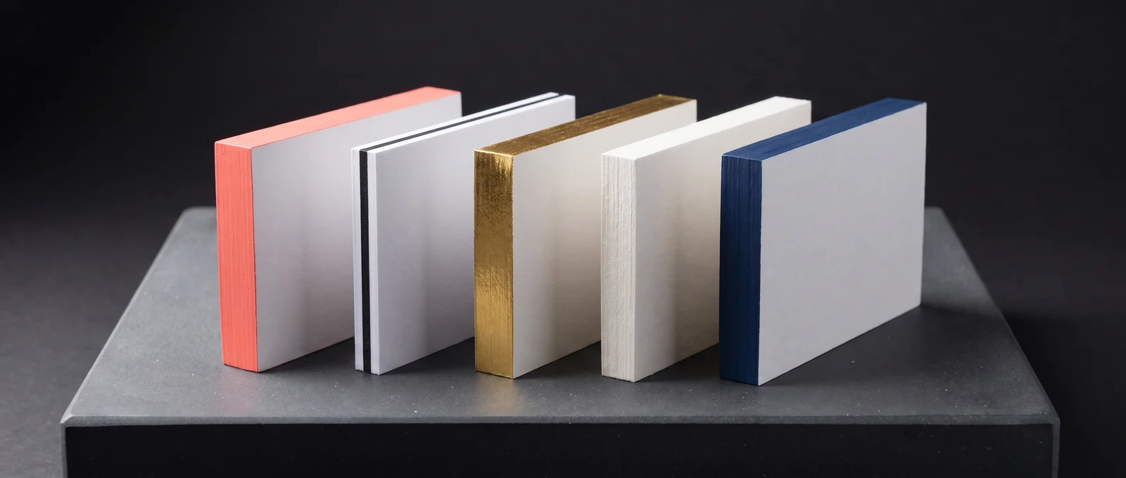 Five thick cards showing different edges: painted, triplex, foiled and natural.