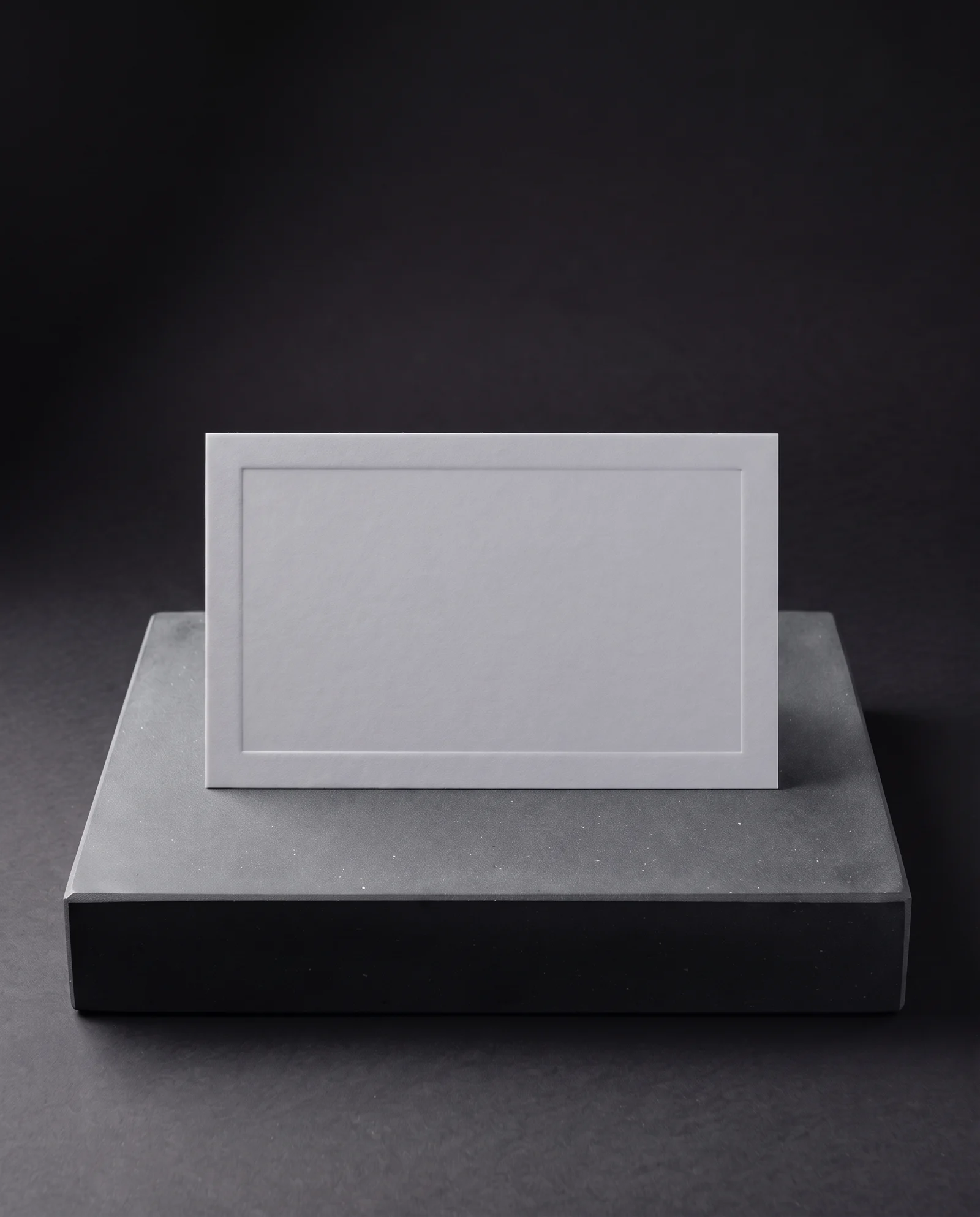 A shallow blind deboss in pale grey soft-touch laminate.