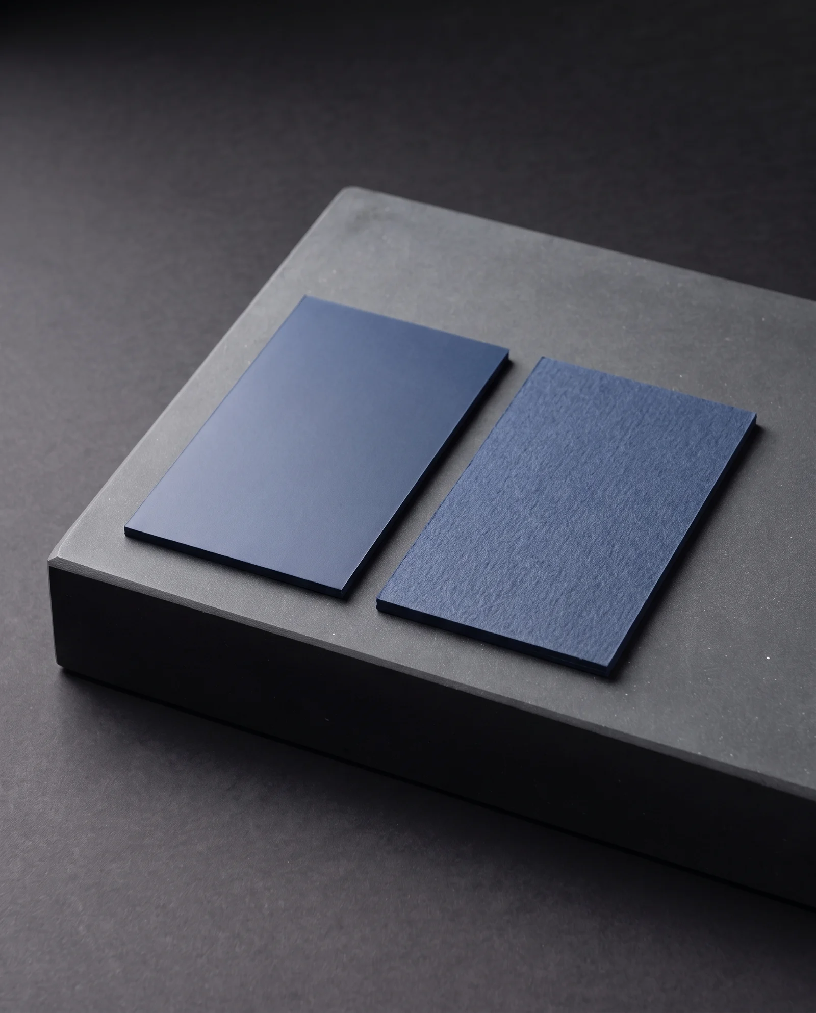 Smooth navy soft-touch beside textured navy uncoated card.