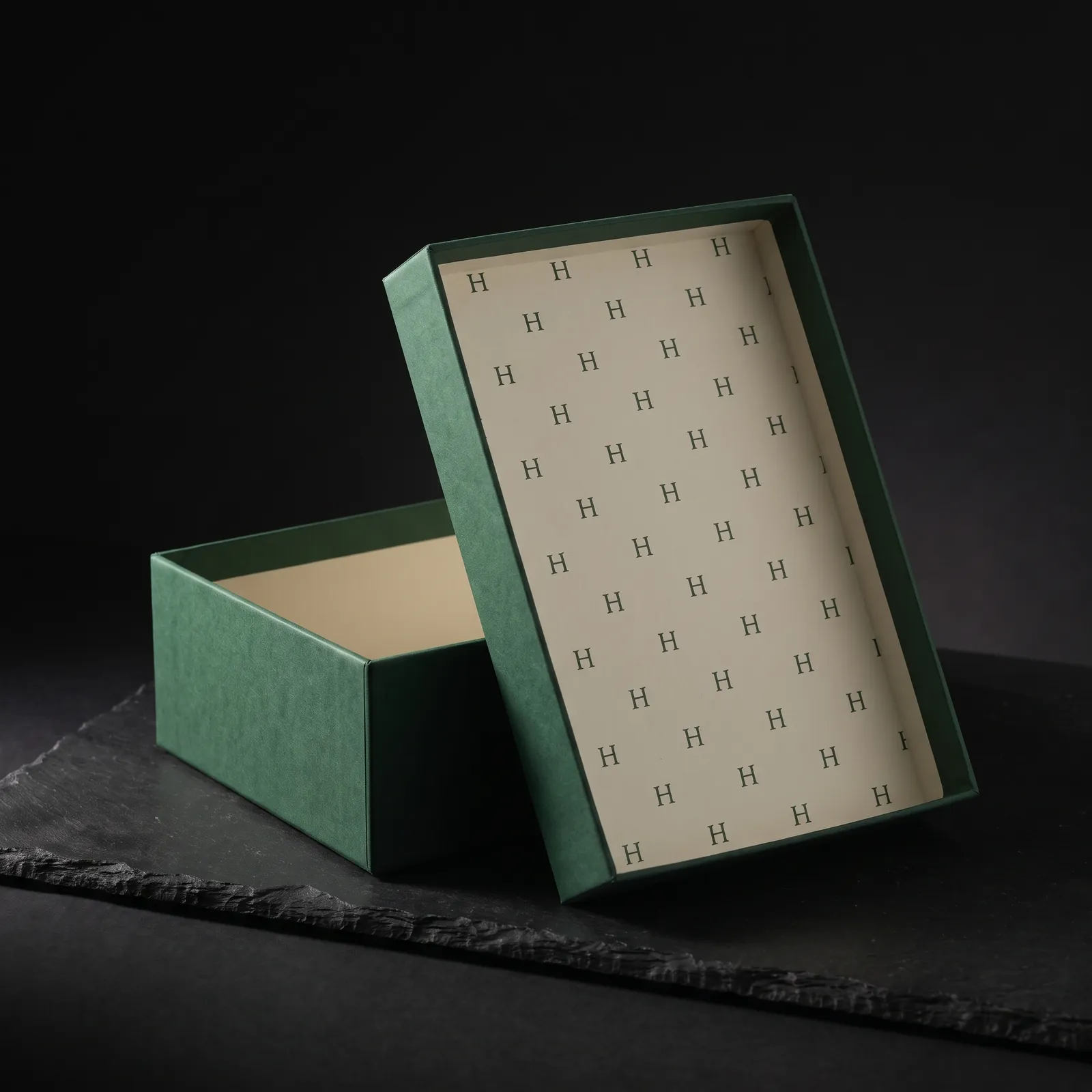 Inside of a box lid printed with a small monogram pattern