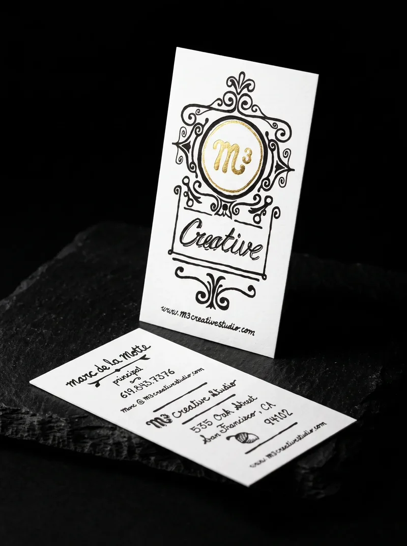 Hand-lettered portrait business card with an ornamental black frame and a gold foil roundel
