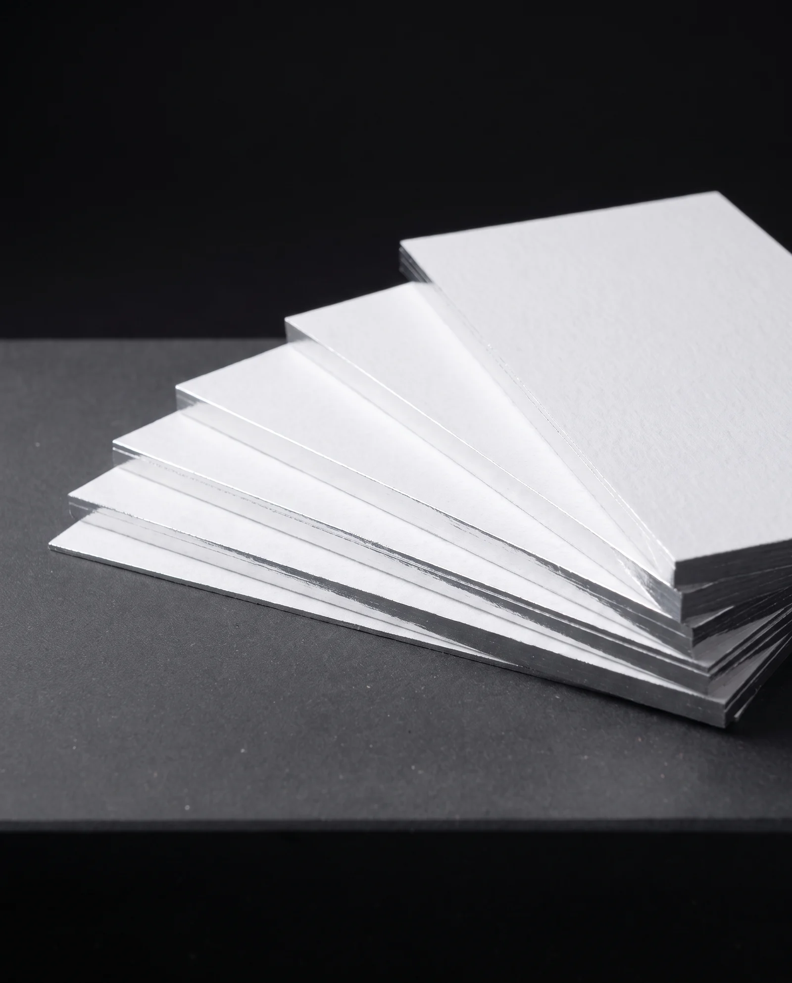 Fanned cards with mirror silver foiled edges.