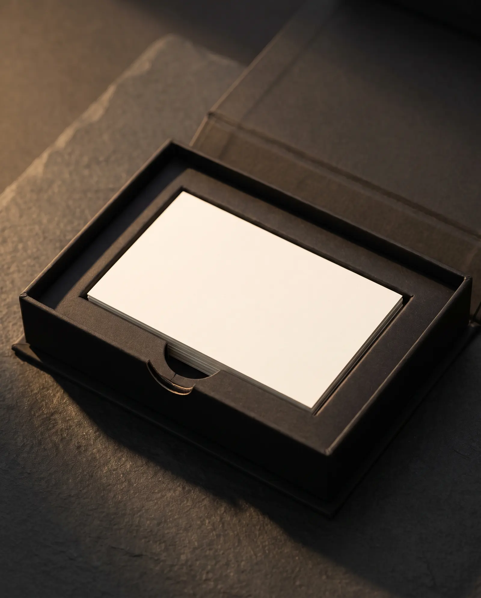 Open black magnetic box, black paperboard tray, blank card stack, half-moon finger cutout