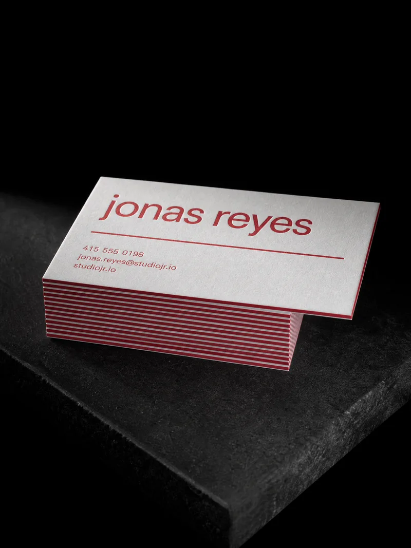 Triplex business card with a red core showing along the edge