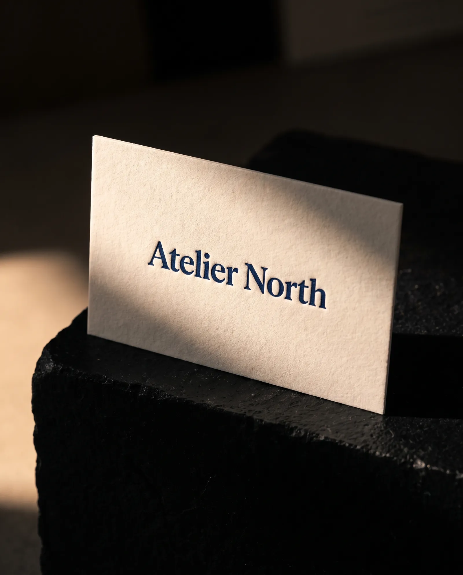 Essential letterpress business card, single navy ink pressed into off-white 48pt cotton