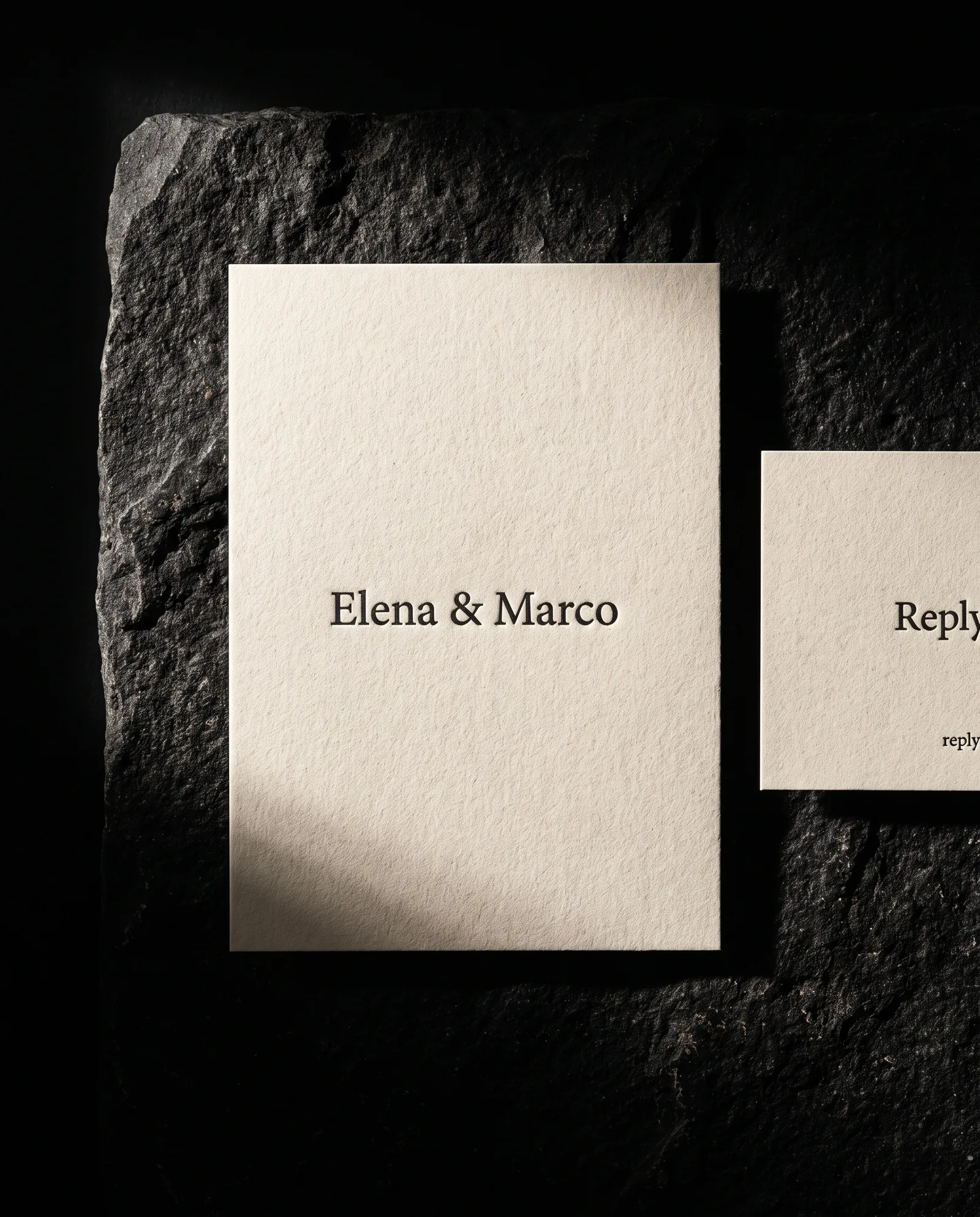 Essential wedding suite: ecru cotton invitation in black letterpress with a matching reply card.