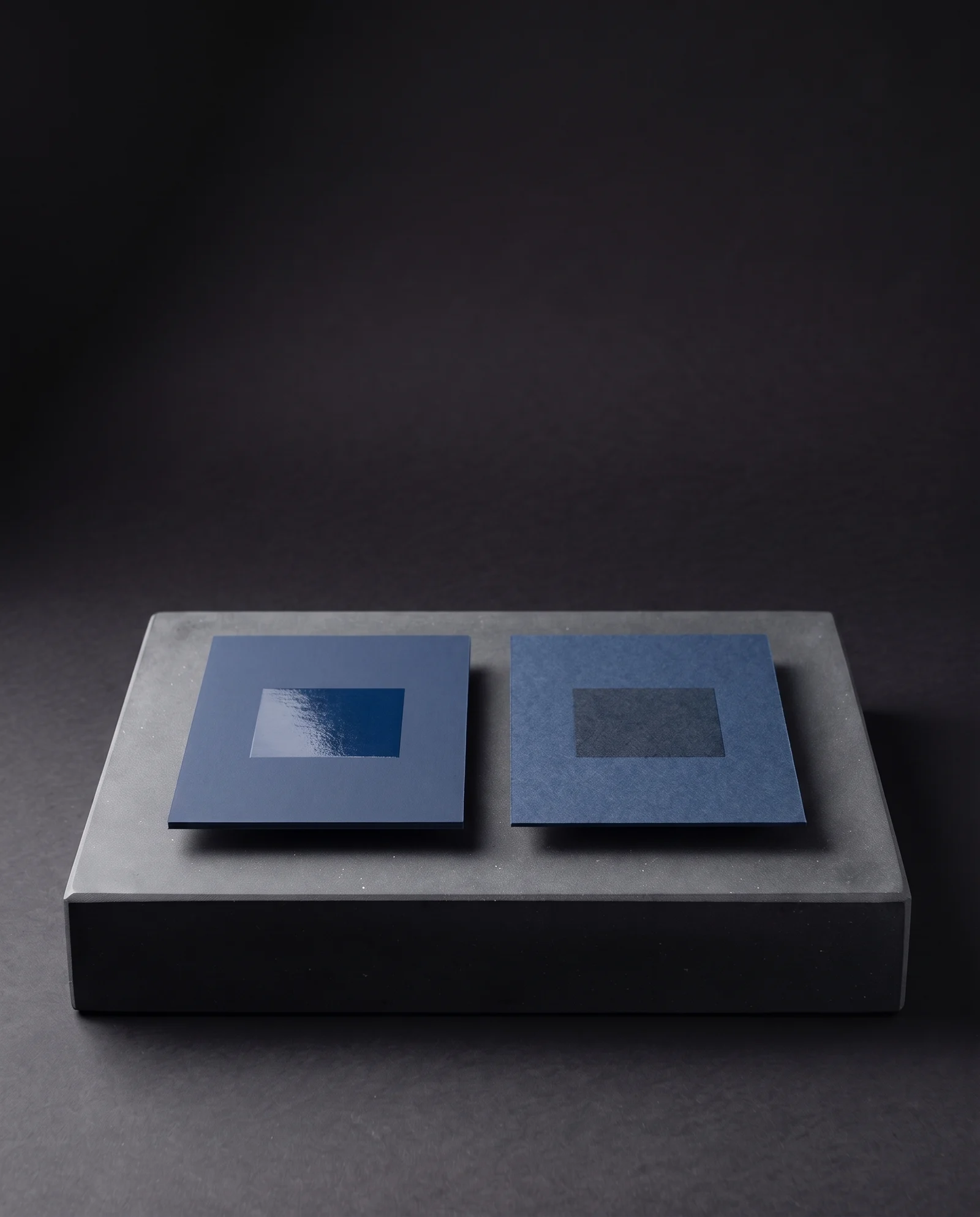 Spot UV bright on soft-touch and dull where it soaked into raw uncoated stock.