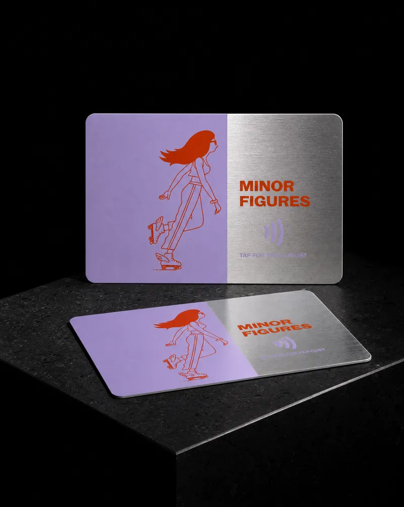 Hybrid steel and lilac PVC NFC business card with a skater illustration, part of the steel left bare