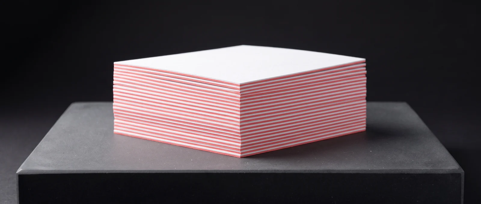 Triplex cards with a coral core showing as a line on every edge.