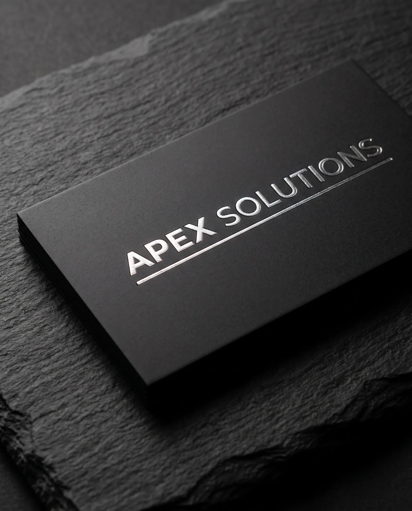 Black PVC plastic business card with silver foil wordmark
