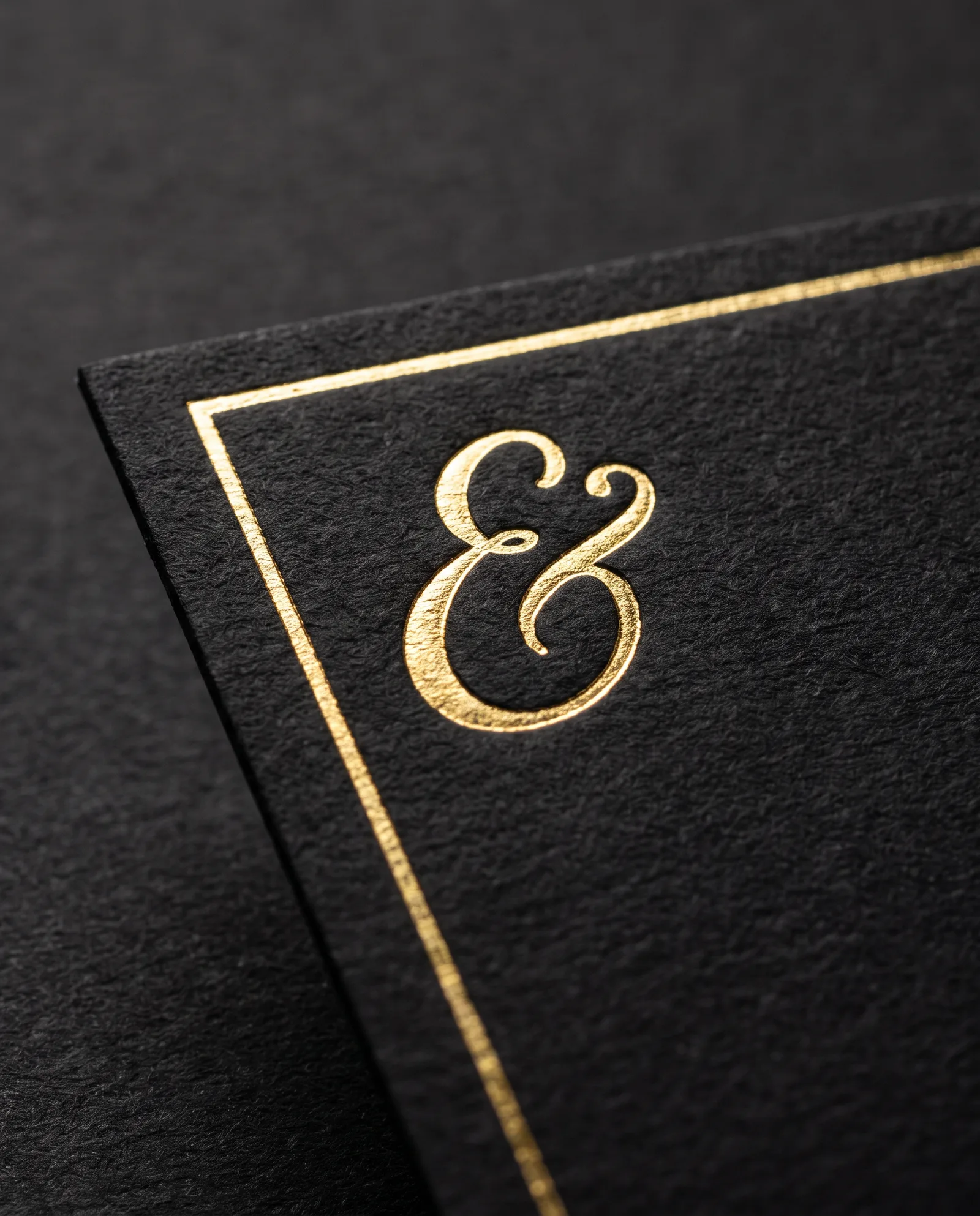 Black business card with gold foil stamped on 32pt true black paper, black edges