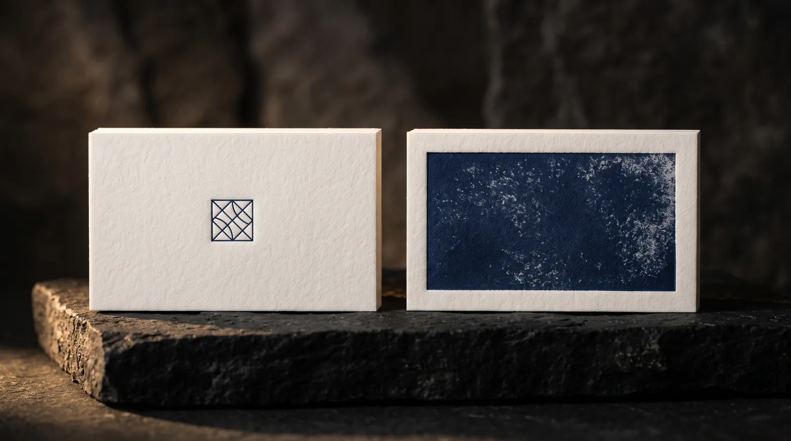Two letterpress cards compared: a fine line mark pressed crisp on cotton, and a large solid area printing with a mottled texture