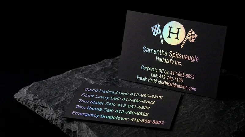 Black business card with racing flags and contact lines in rainbow holographic foil