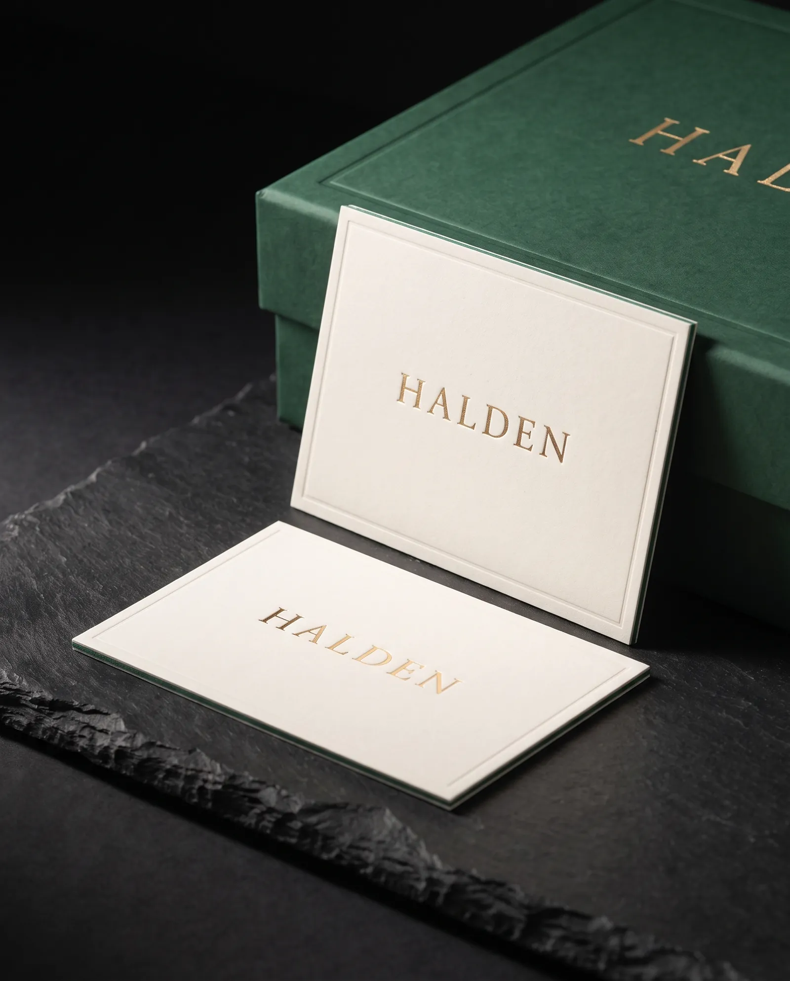 Two ivory cotton insert cards with a gold foil wordmark and a debossed hairline border