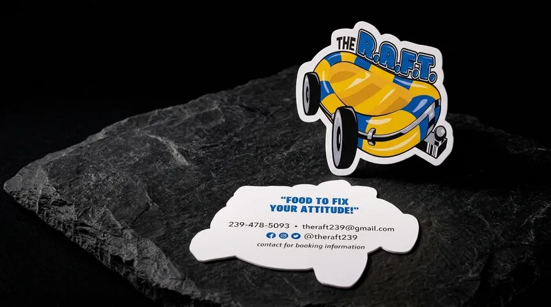 Food truck business card die-cut around a raft-on-wheels mascot like a sticker