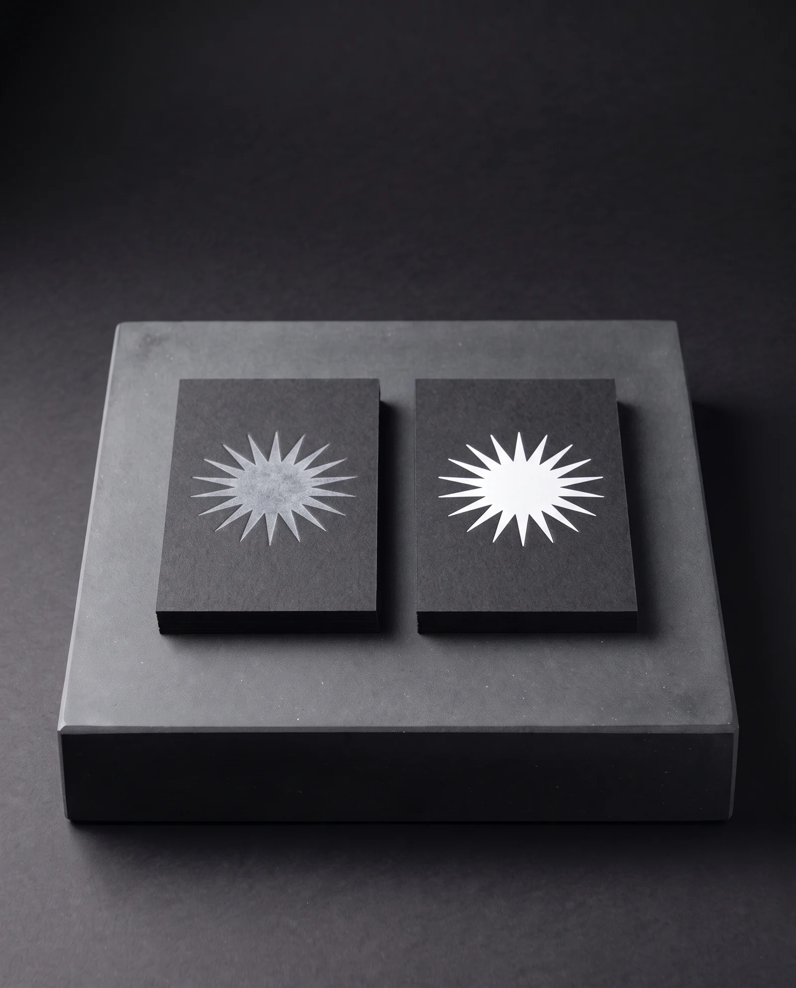 White ink versus white foil on black stock: the ink goes grey, the foil stays opaque.
