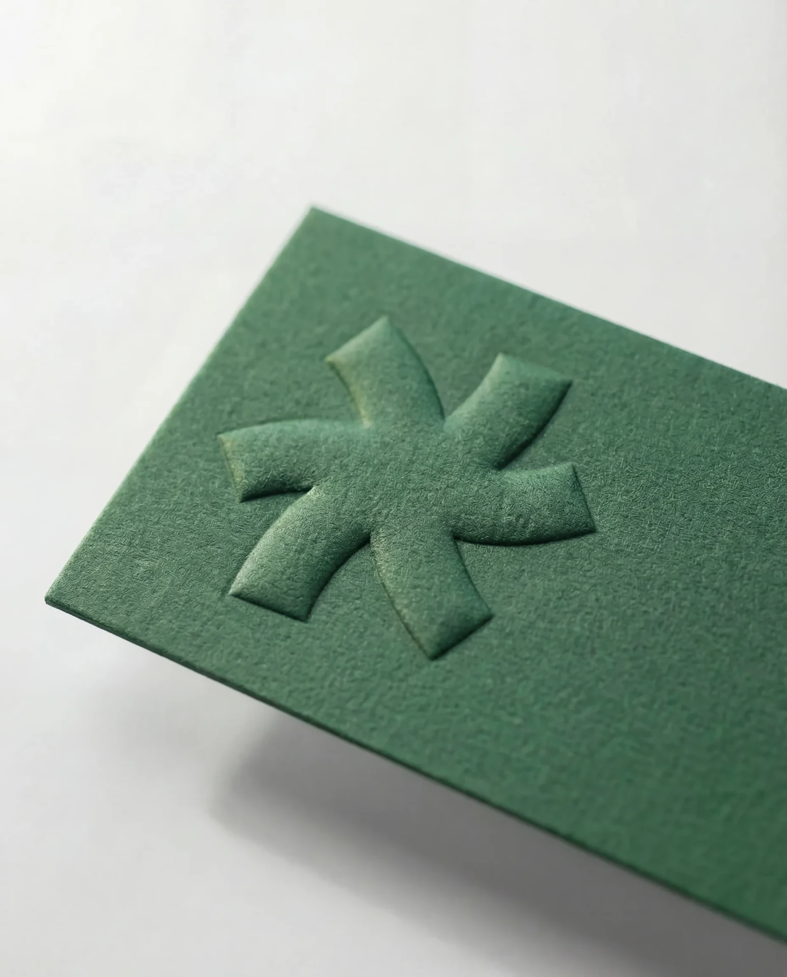 Blind emboss on forest green uncoated business card