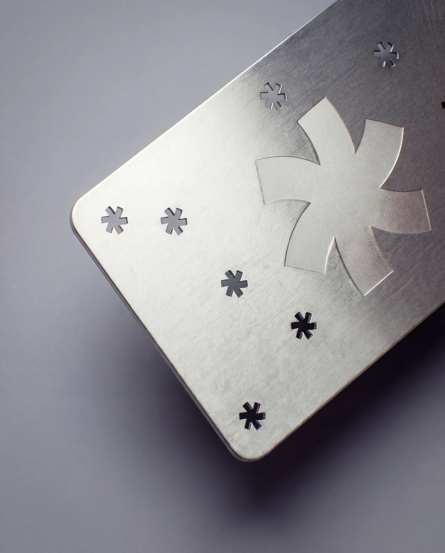 Brushed silver stainless steel business card with laser engraving and cutouts