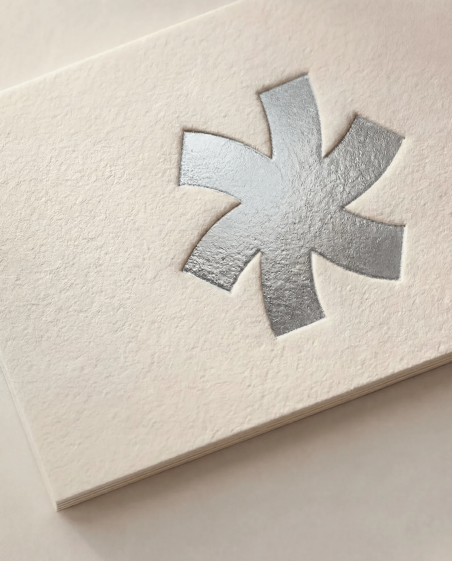 Silver foil stamped into white cotton card