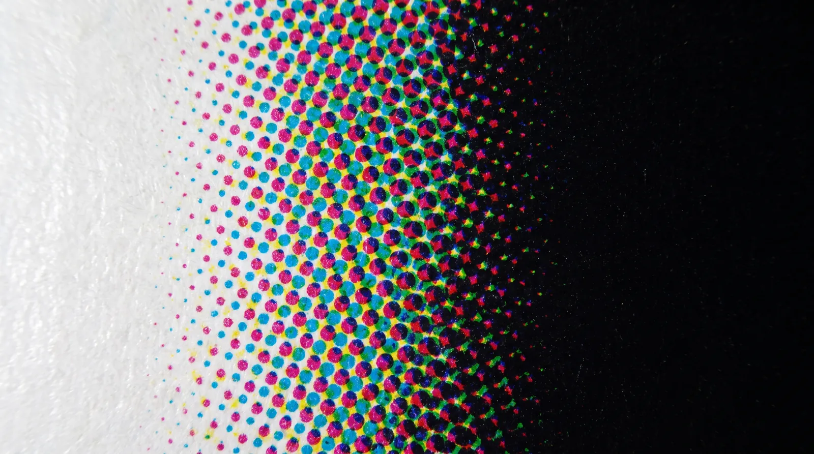 How CMYK actually prints, the 300% ink limit, the one rich black recipe we use and where it never goes, and the type, tint and paper rules that keep four-color work sharp.