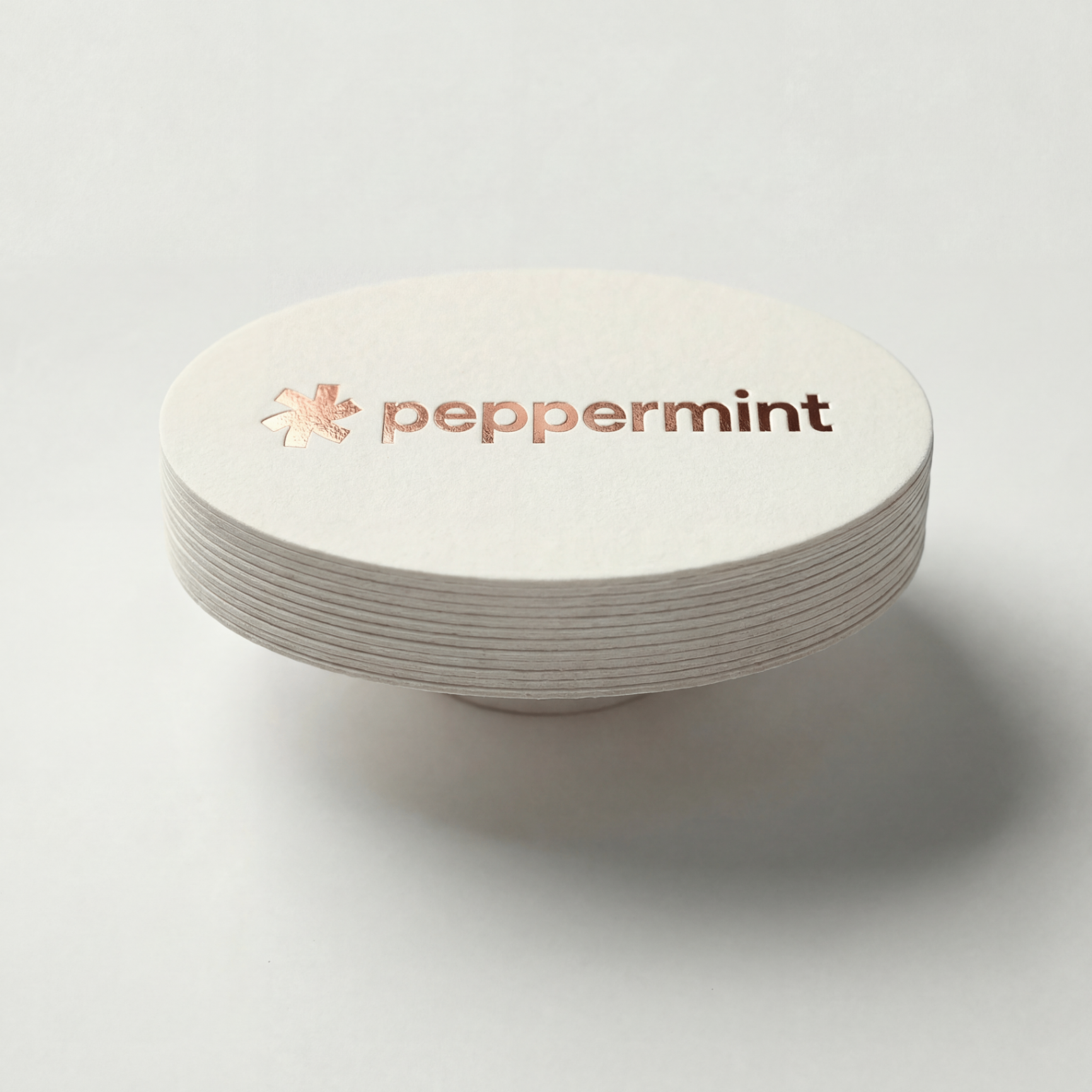 Die-cut business cards in custom shapes laid out on a table