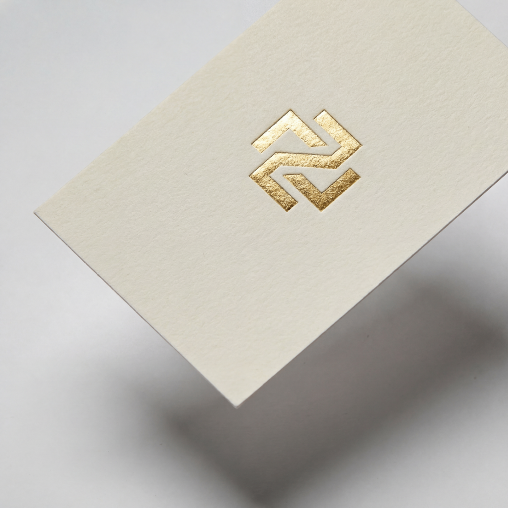 Gold hot foil business card on cotton stock, close-up