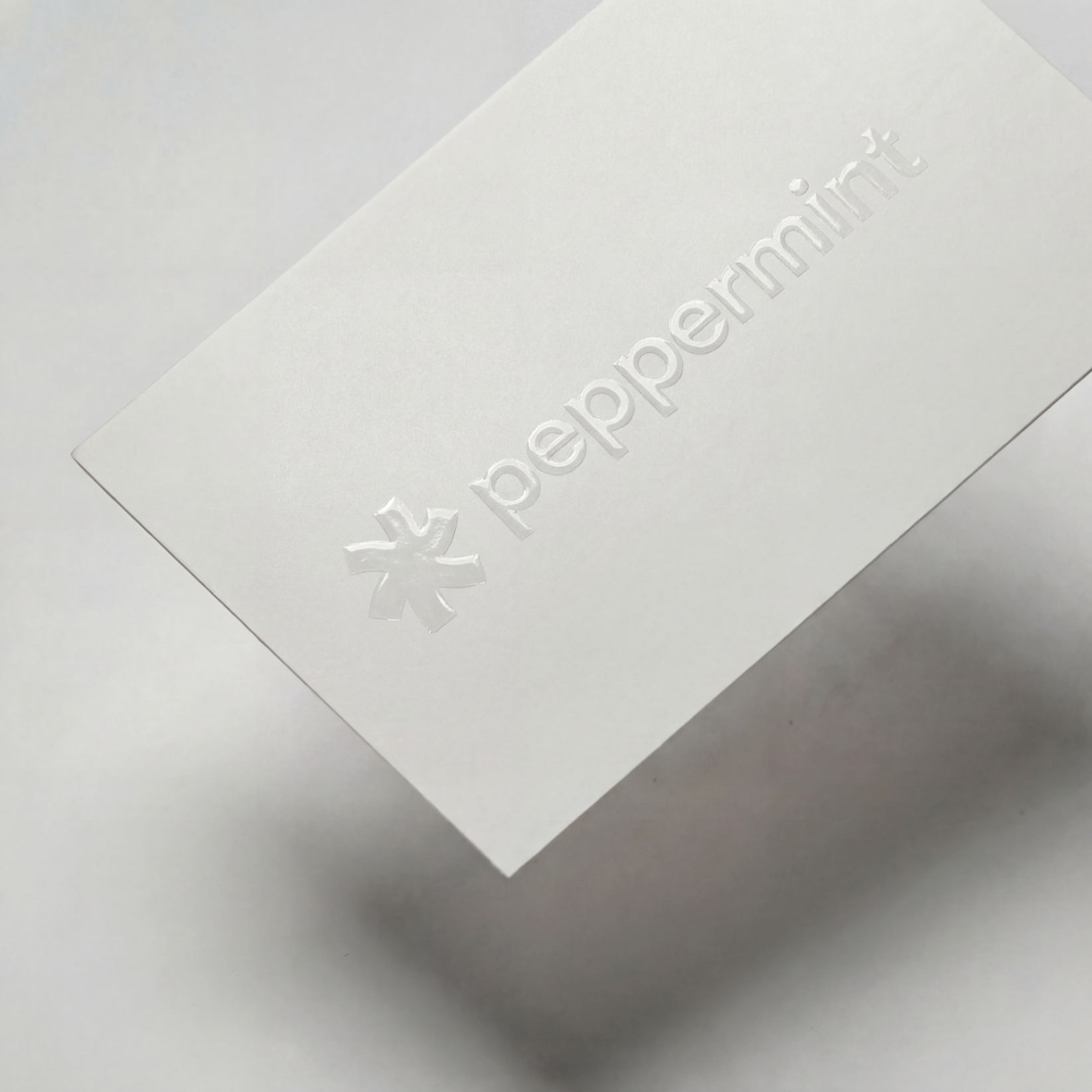 Soft touch business card with clear spot UV gloss on the logo