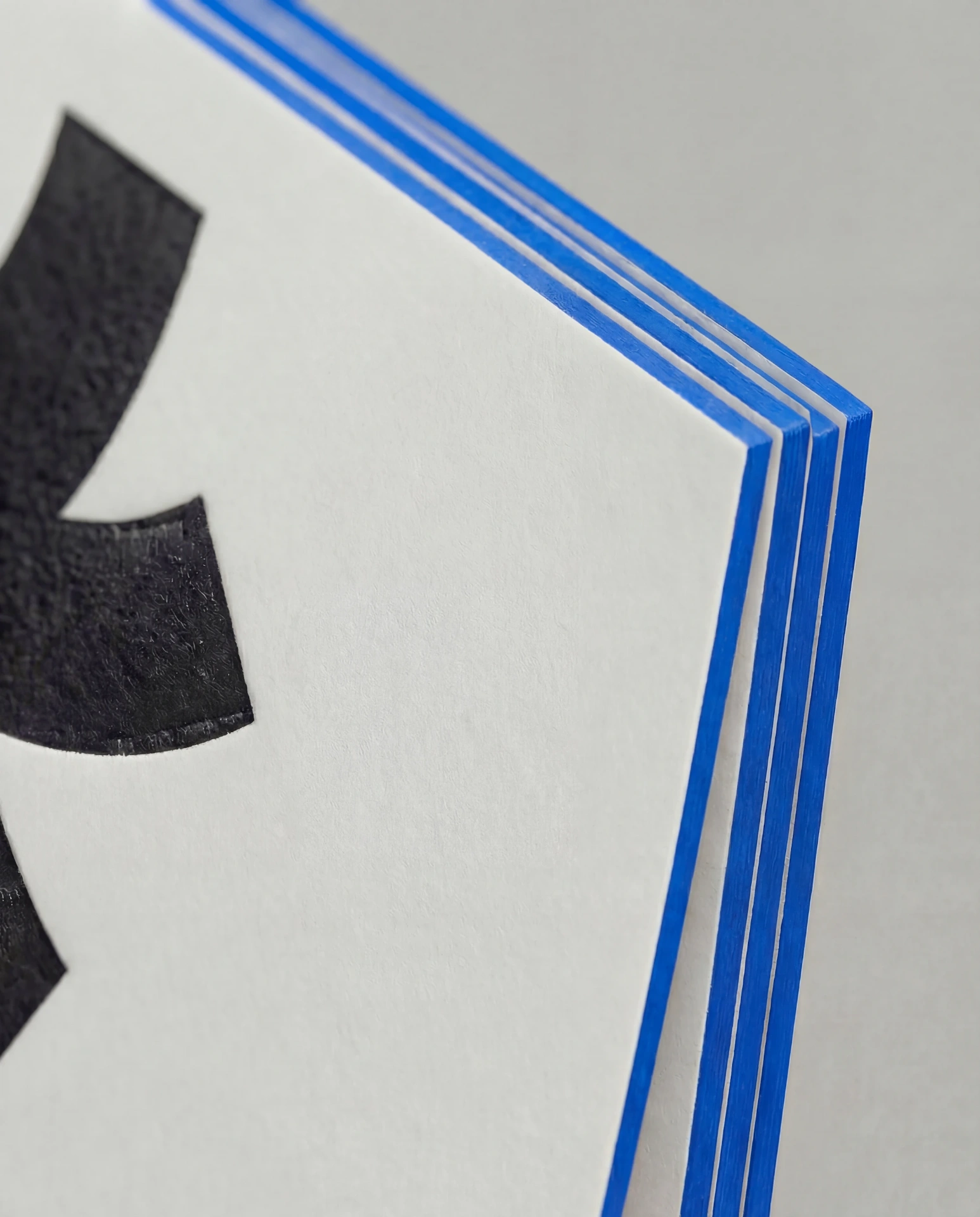 Blue painted edge on a thick paper stack