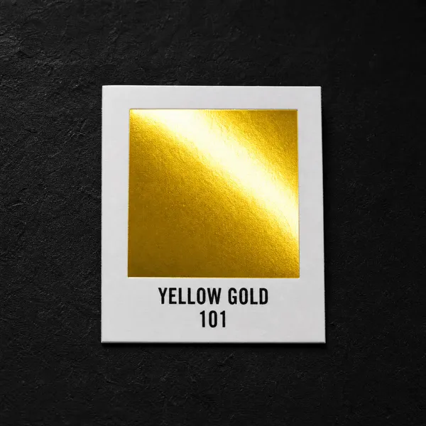 Yellow Gold 101 foil chip photographed on slate