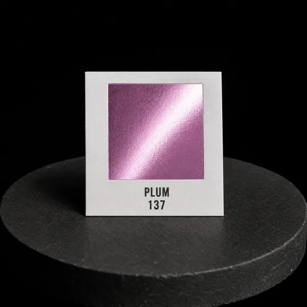 Plum 137 foil chip photographed on slate
